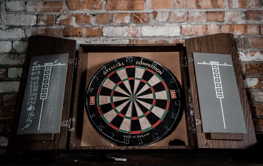 a dartboard on a brick wall