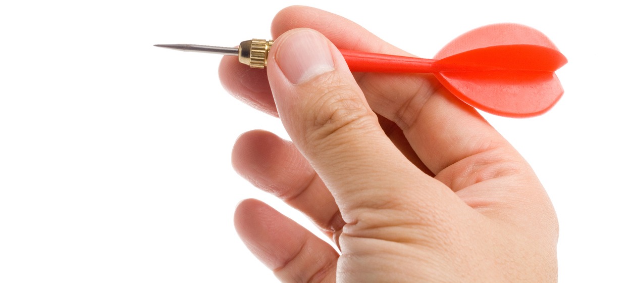 A man holding a dart with visible parts