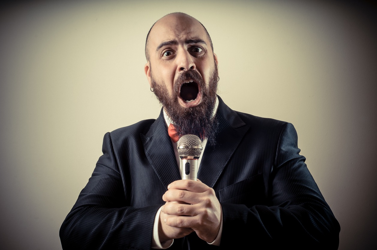 A man singing loudly