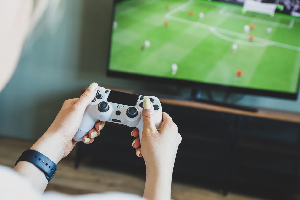 A woman playing football video game