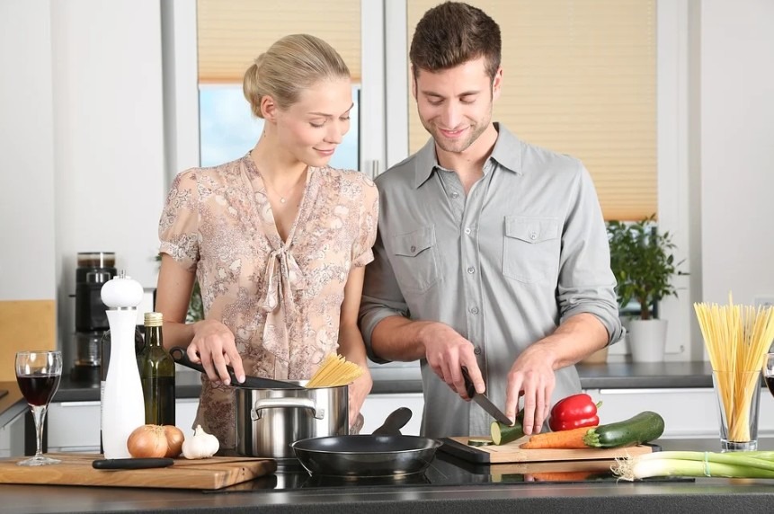 two people cooking in the kitchen