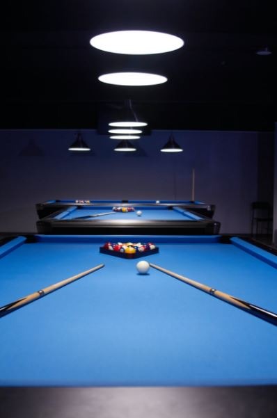 2 Two-piece pool cues on a pool table
