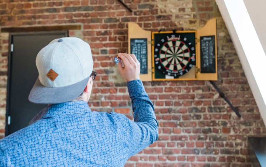man playing darts in a room