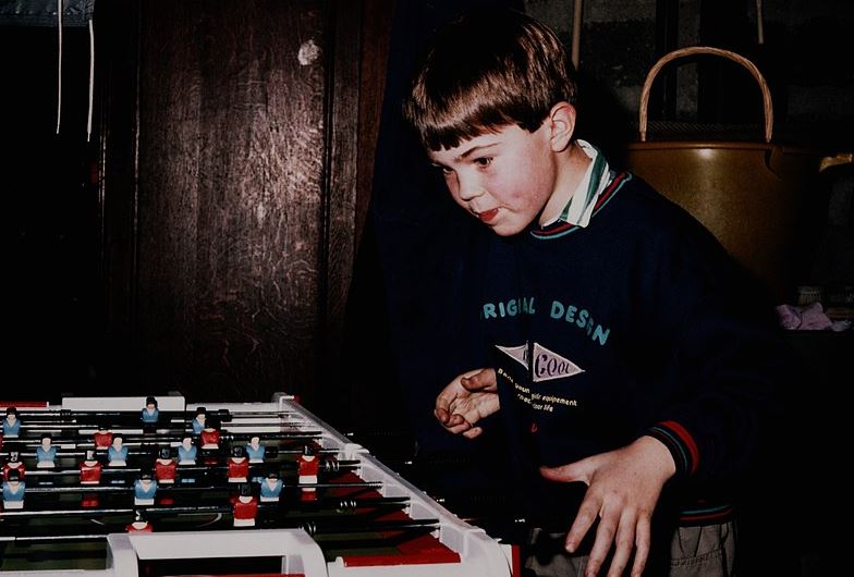 Young boy playing table football in 1989