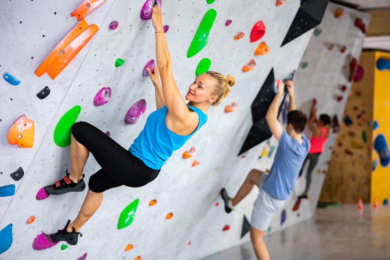 exercising on wall in climbing gym during bouldering training
