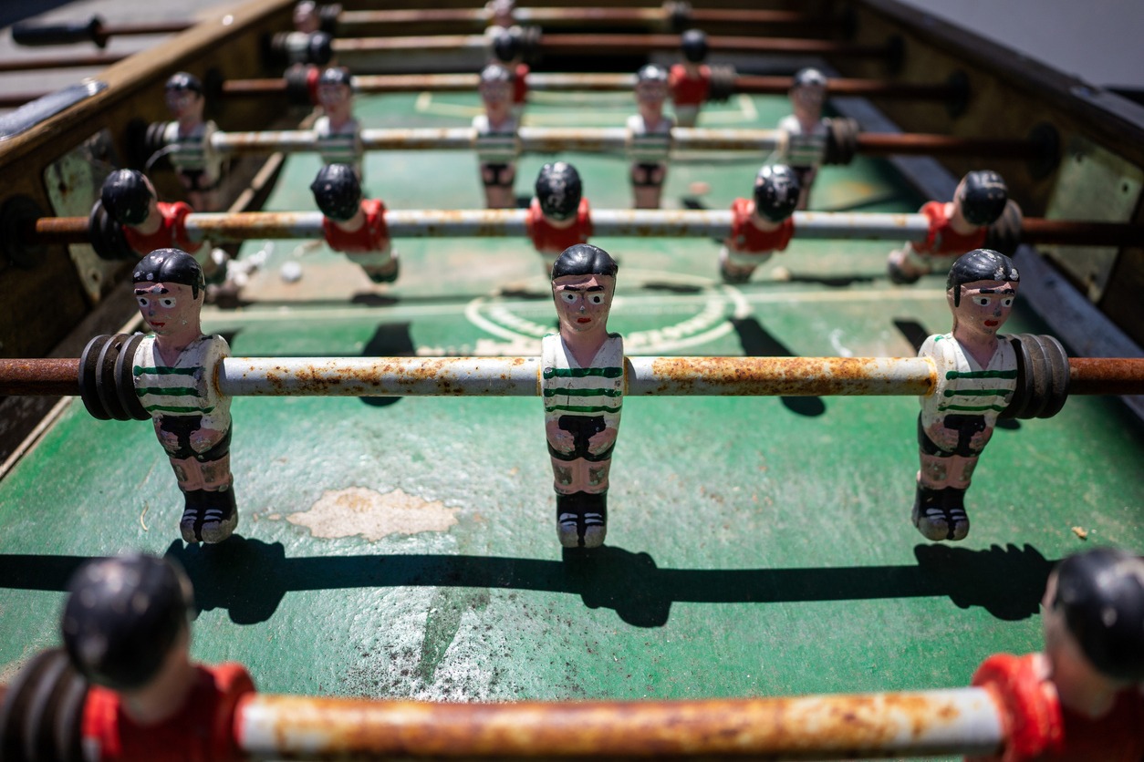 foosball table with dirty rusting rods